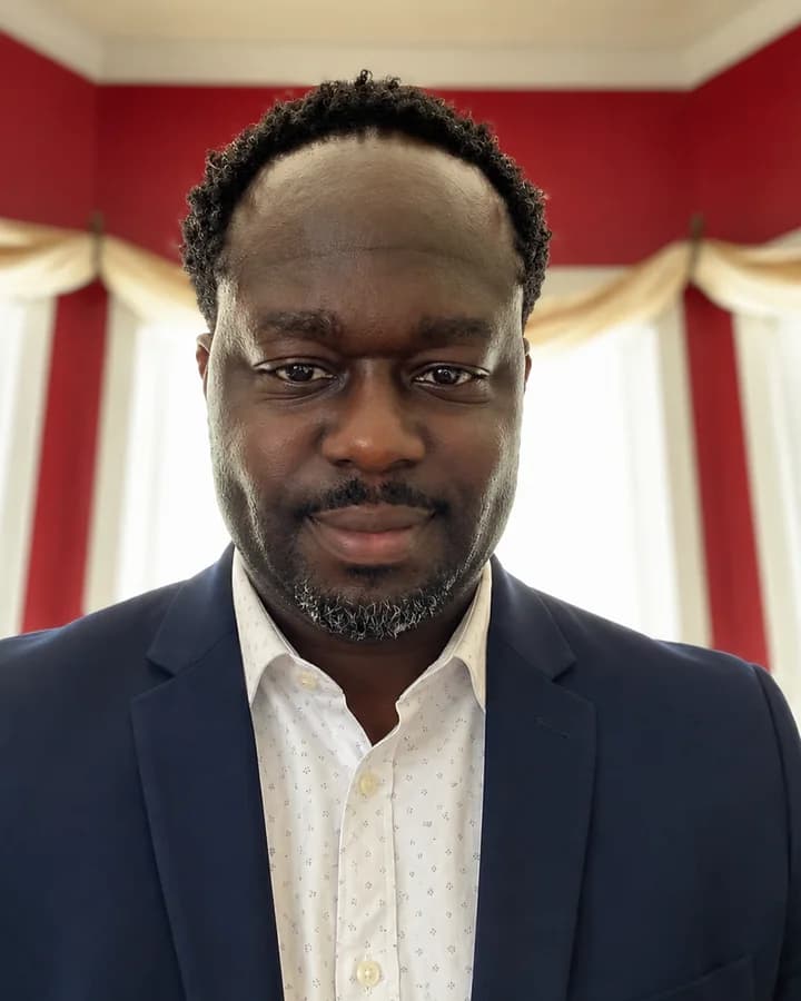 Chevine Anderson, in a navy jacket and a white shirt.